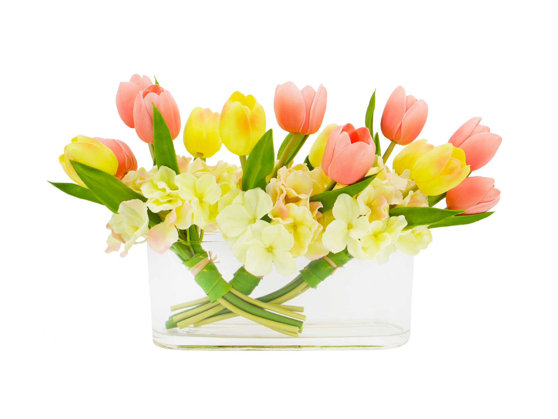 Pink and yellow tulips in low and wide glass vase